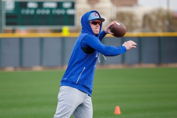 Pete Crow-Armstrong throws a football with other players before warming up during the first day of the Cubs full-squad workout at spring training at Sloan Park on Feb. 16, 2026, in Mesa, Ariz. (Armando L. Sanchez/Chicago Tribune)