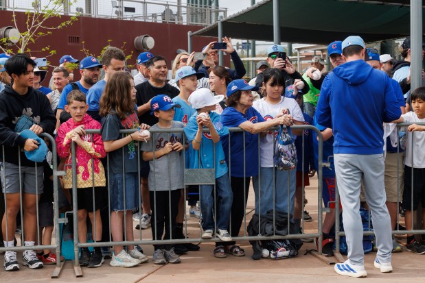 Manager Craig Counsell signs autographs for fans during the first day of the Cubs full-squad workout at spring training at Sloan Park Monday Feb. 16, 2026 in Mesa, Ariz. (Armando L. Sanchez/Chicago Tribune)