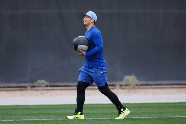 Seiya Suzuki carries a medicine ball during the first day of the Cubs full-squad workout at spring training at Sloan Park Monday Feb. 16, 2026 in Mesa, Ariz. (Armando L. Sanchez/Chicago Tribune)