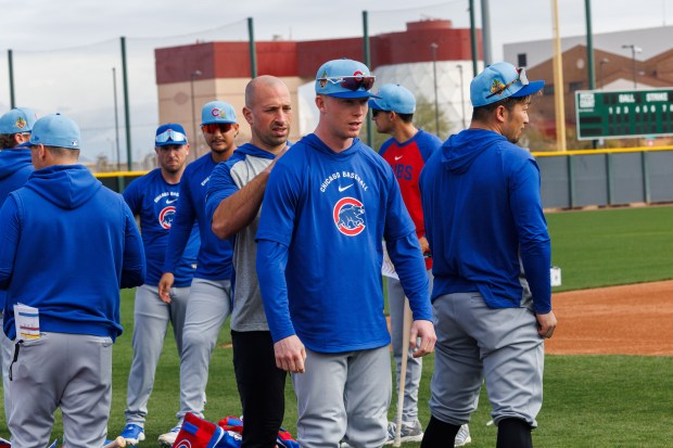 A Cubs strength and conditioning coach puts Pete Crow-Armstrong's hood up before warming up at spring training on Feb. 18, 2026, at Sloan Park in Mesa, Ariz. (Armando L. Sanchez/Chicago Tribune)