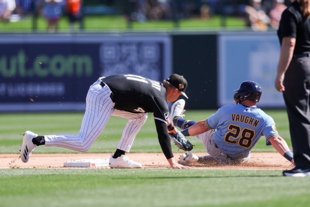 Milwaukee Brewers first baseman Andrew Vaughn (28) steals second base past Chicago White Sox shortstop Tanner Murray (41) during the first inning in a Cactus League game at Camelback Ranch on Sunday, Feb. 22, 2026, in Glendale, Ariz. (Armando L. Sanchez/Chicago Tribune)