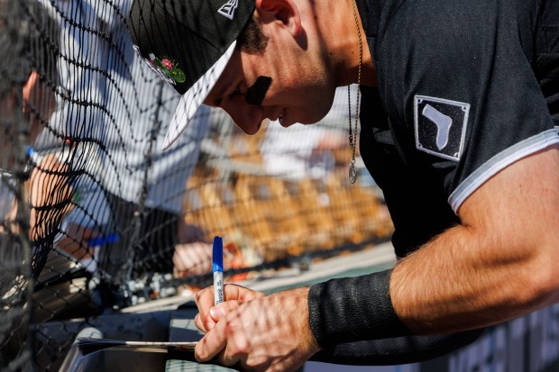 Chicago White Sox catcher Drew Romo (36) signs autographs before playing the Milwaukee Brewers in a Cactus League game at Camelback Ranch on Sunday, Feb. 22, 2026, in Glendale, Ariz. (Armando L. Sanchez/Chicago Tribune)