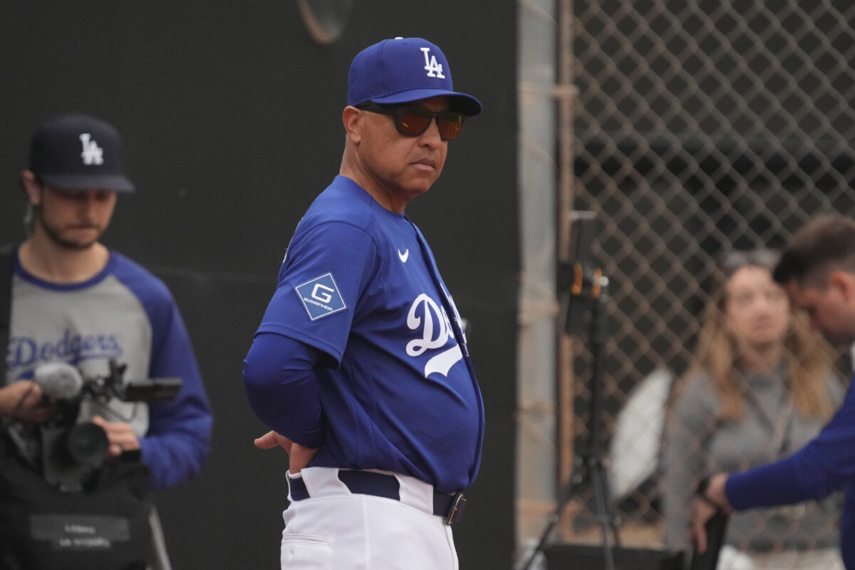 Feb 13, 2026; Glendale, AZ, USA; Los Angeles Dodgers manager Dave Roberts (30) watches from the bullpen during spring training camp. Mandatory Credit: Rick Scuteri-Imagn Images