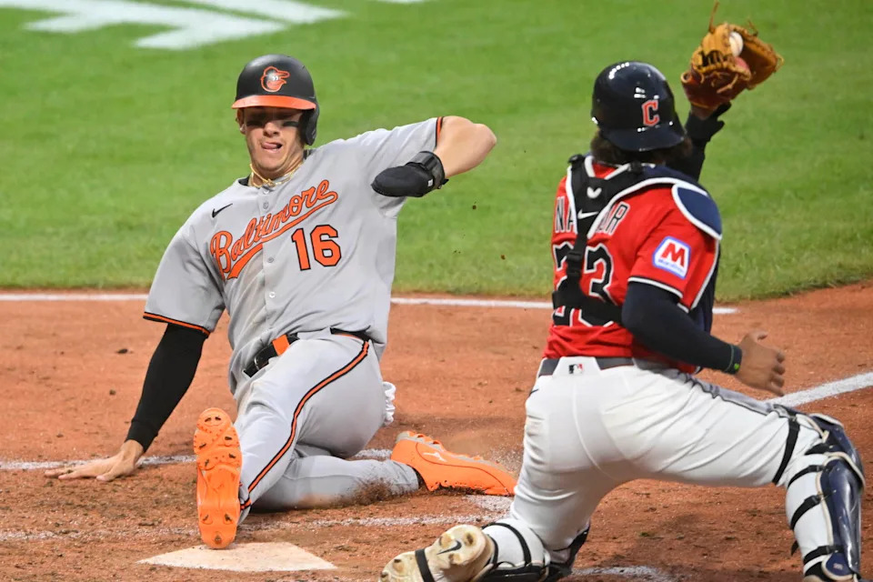 Jul 22, 2025; Cleveland, Ohio, USA; Baltimore Orioles first baseman Coby Mayo (16) scores beside Cleveland Guardians catcher Bo Naylor (23) in the seventh inning at Progressive Field. Mandatory Credit: David Richard-Imagn Images