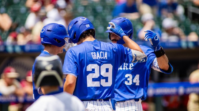 AJ Gracia celebrates with Duke baseball players on the field.