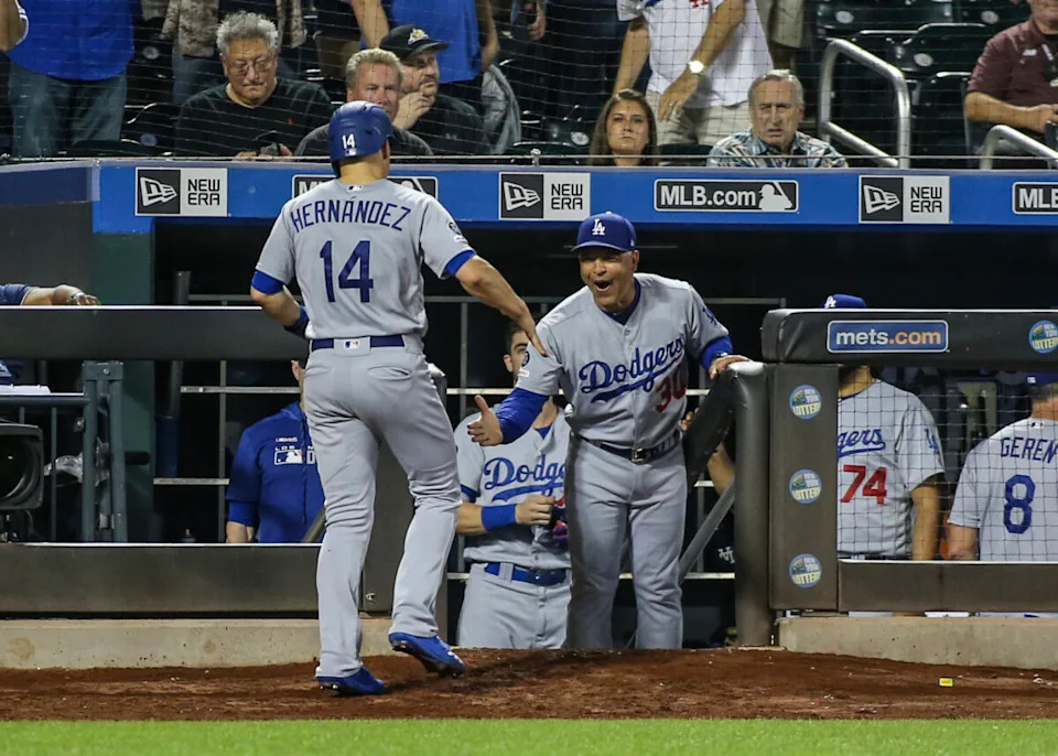 Los Angeles Dodgers manager Dave Roberts (30) congratulates left fielder Kike Hernandez (14) after scoring in the ninth inning against the New York Mets at Citi Field.