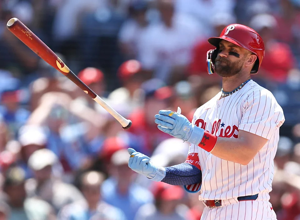 Jul 4, 2025; Philadelphia, Pennsylvania, USA; Philadelphia Phillies first base Bryce Harper (3) tosses his bat after striking out to end the sixth inning against the Cincinnati Reds at Citizens Bank Park. Mandatory Credit: Bill Streicher-Imagn Images