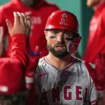 Los Angeles Angels center fielder Kevin Pillar (12) is congratulated in the dugout against the Kansas City Royals after scoring in the sixth inning at Kauffman Stadium on Aug 20, 2024.