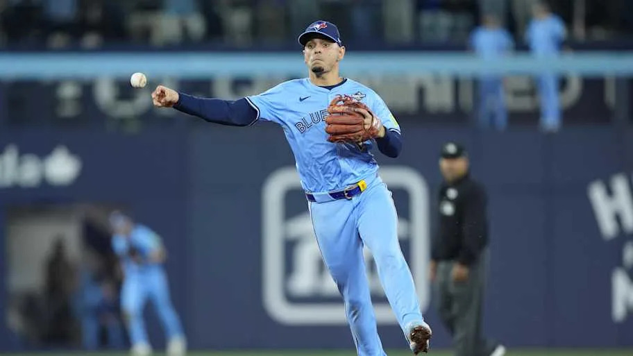 Gimenez throwing a ball in a baby blue Blue Jays uniform