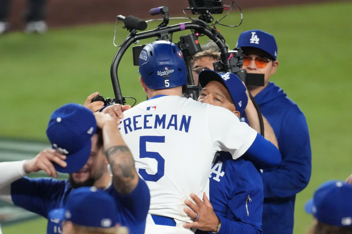 Oct 27, 2025; Los Angeles, California, USA; Los Angeles Dodgers first baseman Freddie Freeman (5) celebrates with manager Dave Roberts (30) after hitting a walk off home run in the eighteenth inning against the Toronto Blue Jays during game three of the 2025 MLB World Series at Dodger Stadium. Mandatory Credit: Kirby Lee-Imagn Images