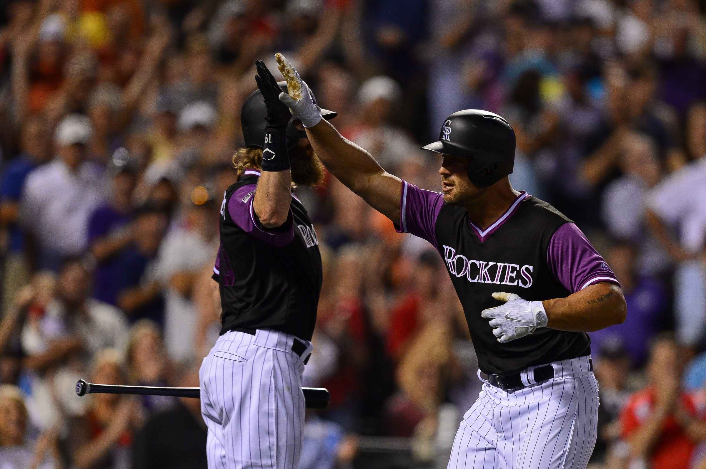 DENVER, CO - AUGUST 25: Matt Holliday #7 of the Colorado Rockies is congratulated by Charlie Blackmon #19 after hitting a seventh inning solo homerun against the St. Louis Cardinals at Coors Field on August 25, 2018 in Denver, Colorado. Players are wearing special jerseys with their nicknames on them during Players’ Weekend. (Photo by Dustin Bradford/Getty Images)