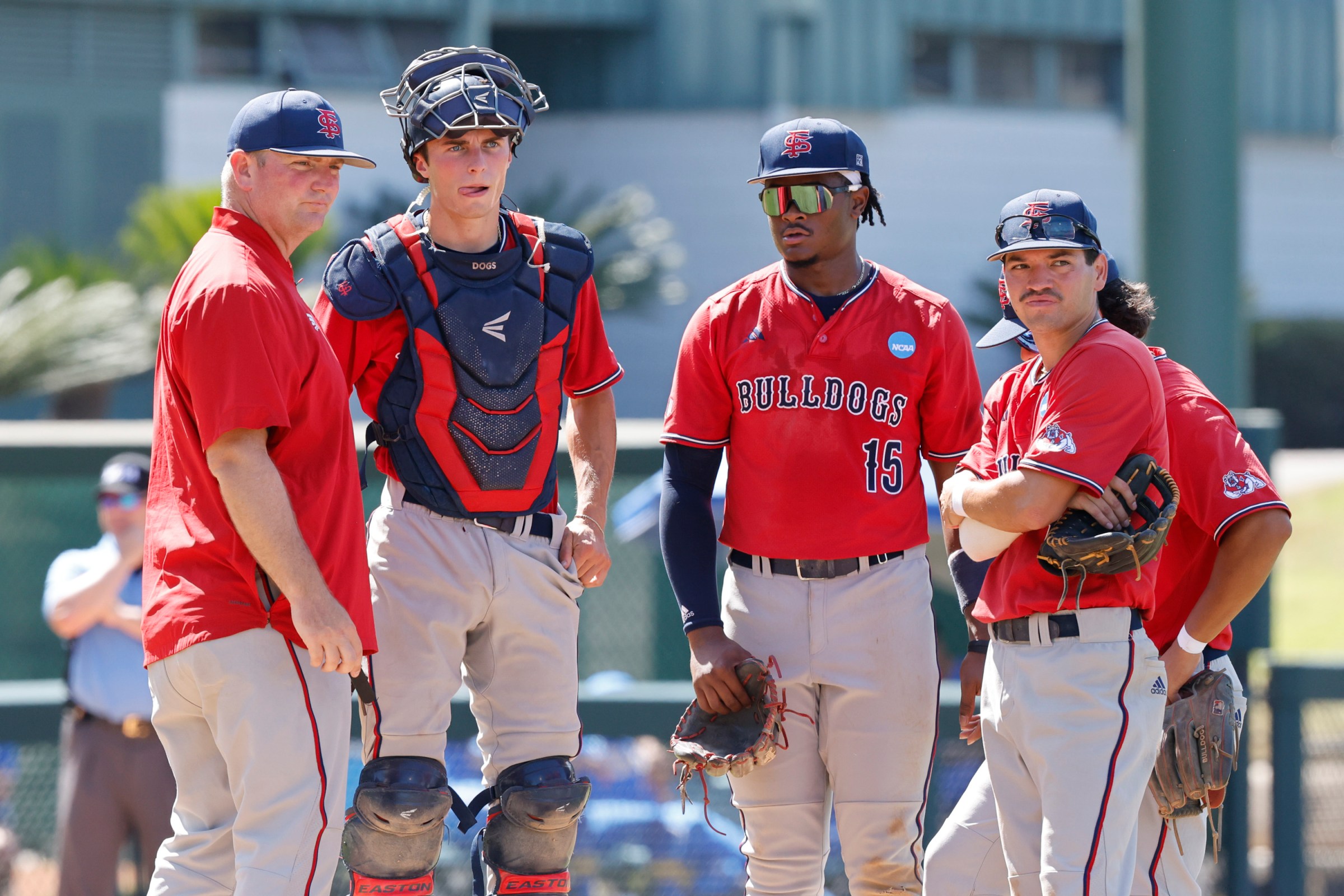 Los Angeles, CA - May 30: Fresno State Head Coach Ryan Overland (left) walks up to the mound at the NCAA baseball regional tournament game between UCLA and Fresno State at Jackie Robinson Stadium on Friday, May 30, 2025 in Los Angeles, CA. (Carlin Stiehl / Los Angeles Times via Getty Images)