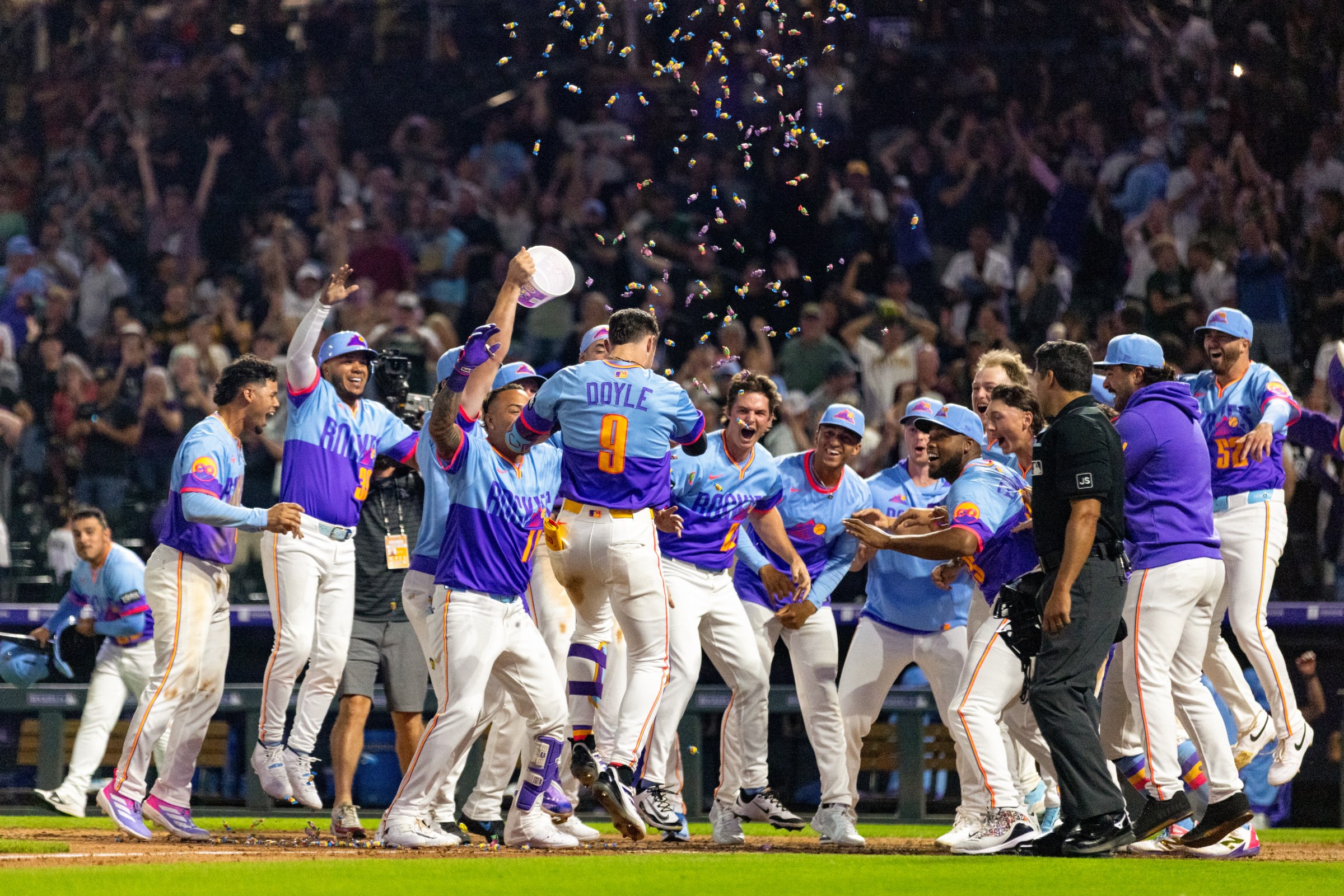 DENVER, CO - AUGUST 01: Brenton Doyle #9 of the Colorado Rockies celebrates with teammates at home plate after hitting a walk-off home run during the game between the Pittsburgh Pirates and the Colorado Rockies at Coors Field on Friday, August 1, 2025 in Denver, Colorado. (Photo by Casey Paul/MLB Photos via Getty Images)