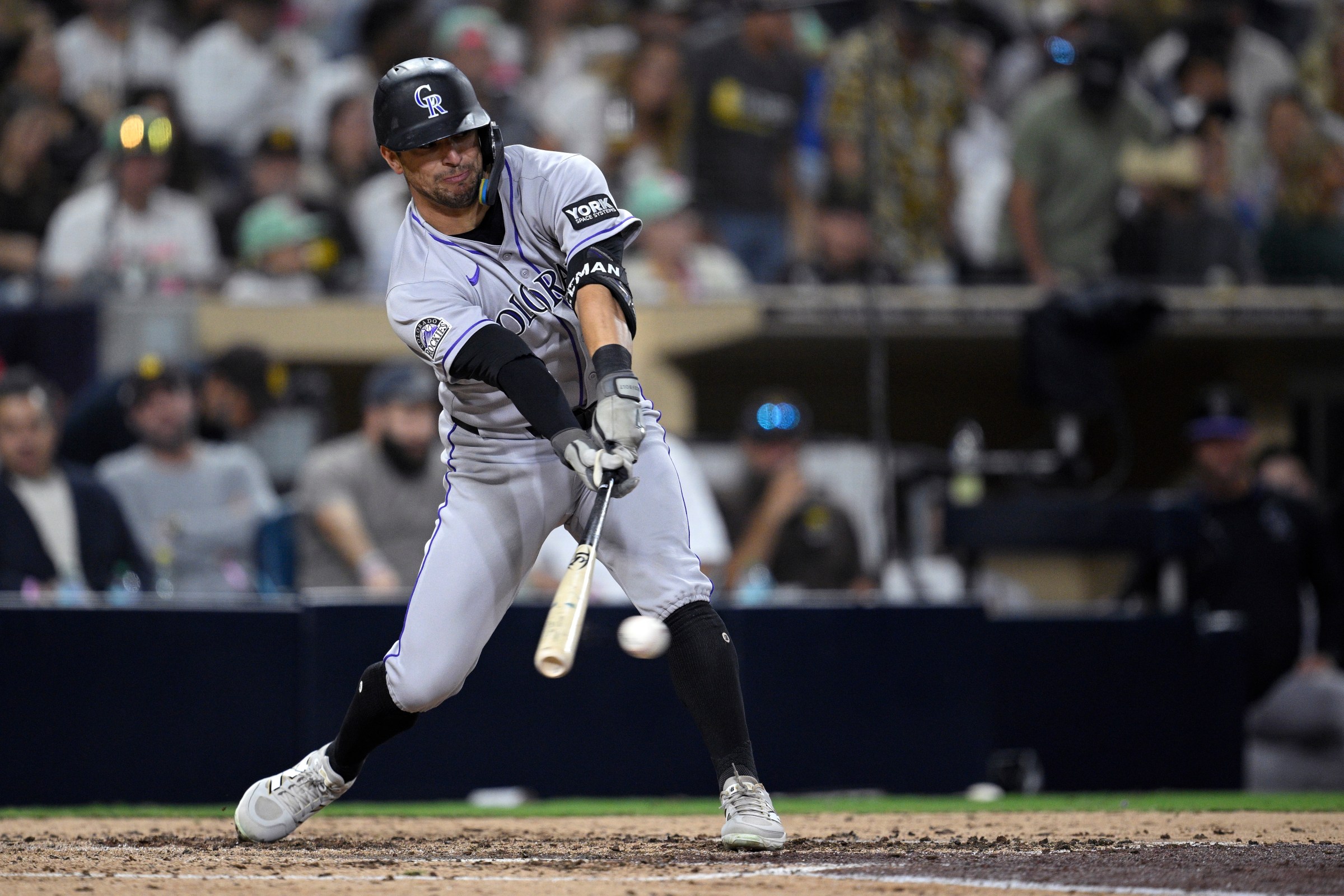 SAN DIEGO, CALIFORNIA - SEPTEMBER 12: Tyler Freeman #2 of the Colorado Rockies hits a single during the seventh inning against the San Diego Padres at Petco Park on September 12, 2025 in San Diego, California. (Photo by Orlando Ramirez/Getty Images)