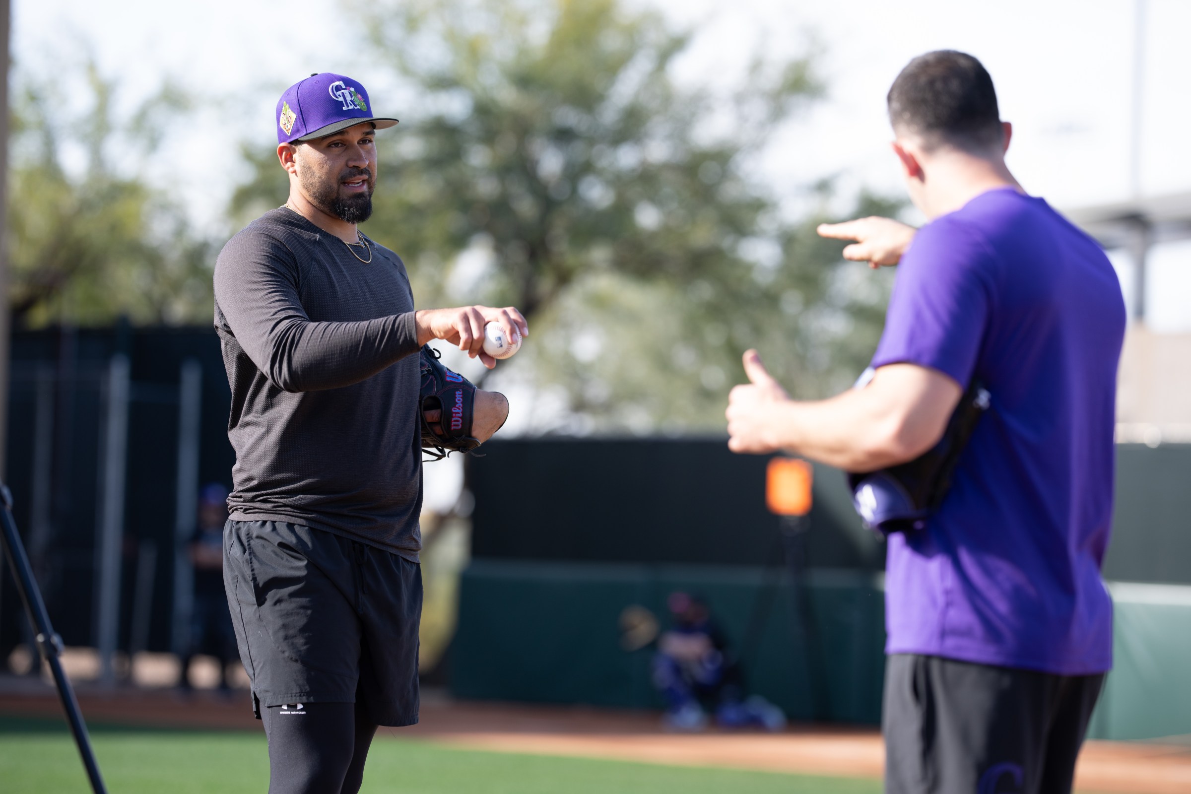 SCOTTSDALE, ARIZONA - FEBRUARY 10: Pitching Coach Alon Leichman #77 of the Colorado Rockies talks to pitcher Antonio Senzatela #49 about pitching grips at Salt River Fields at Talking Stick on February 10, 2026 in Scottsdale, Arizona. (Photo by Kyle Cooper/Colorado Rockies/Getty Images)