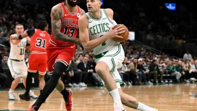 BOSTON, MASSACHUSETTS - FEBRUARY 11: Nikola Vucevic #4 of the Boston Celtics goes to the basket against Nick Richards #13 of the Chicago Bulls during the first half at the TD Garden on February 11, 2026 in Boston, Massachusetts. NOTE TO USER: User expressly acknowledges and agrees that, by downloading and or using this photograph, User is consenting to the terms and conditions of the Getty Images License Agreement. (Photo by Brian Fluharty/Getty Images)