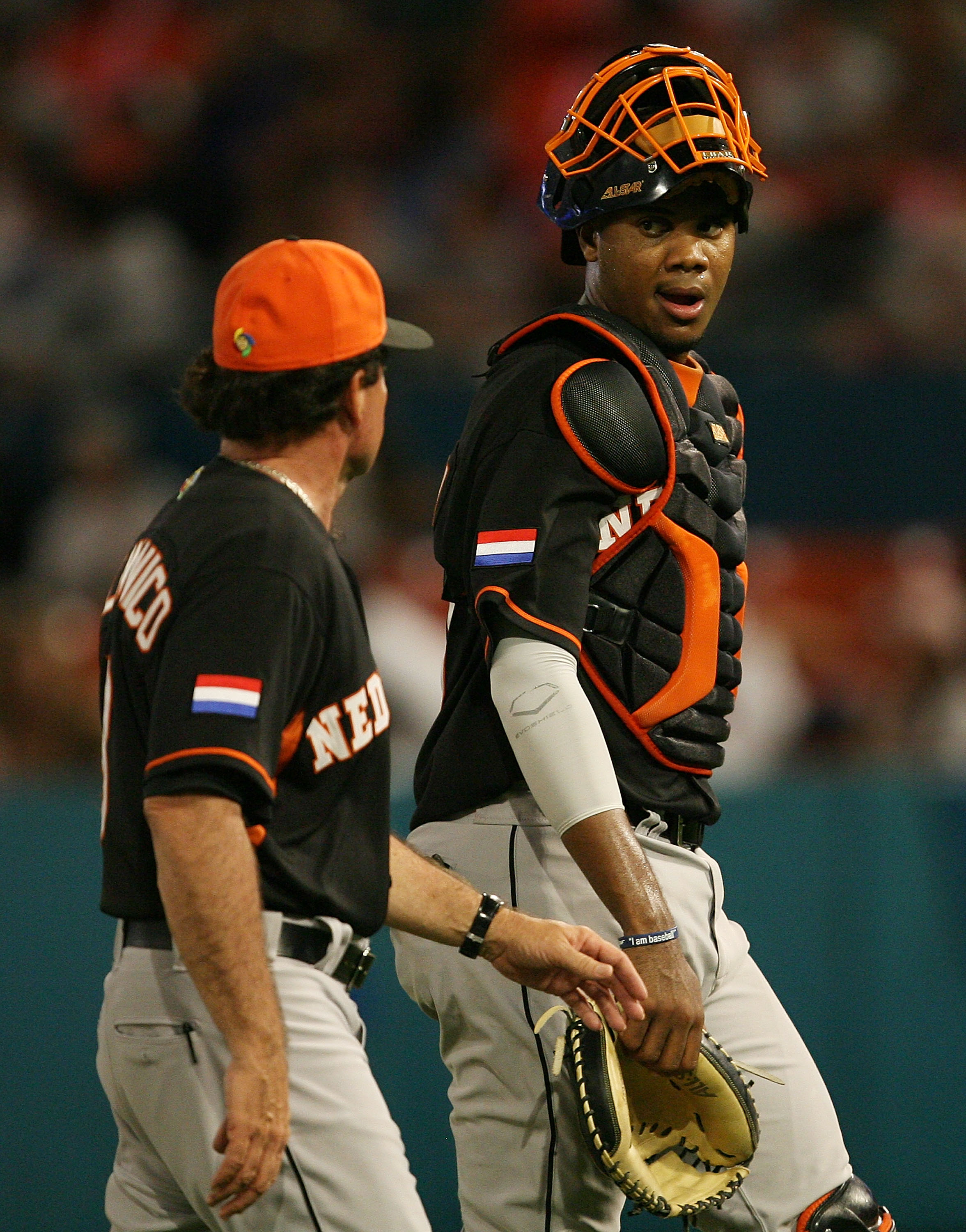 MIAMI - MARCH 15: Manager Rod Delmonico #8 talks with catcher Kenley Jansen #50 of the Netherlands after talking with his pitcher in the fifth inning against the United States during round 2 of the World Baseball Classic at Dolphin Stadium on March 15, 2009 in Miami, Florida. The United States eliminated the Netherlands 9-3. (Photo by Doug Benc/Getty Images)
