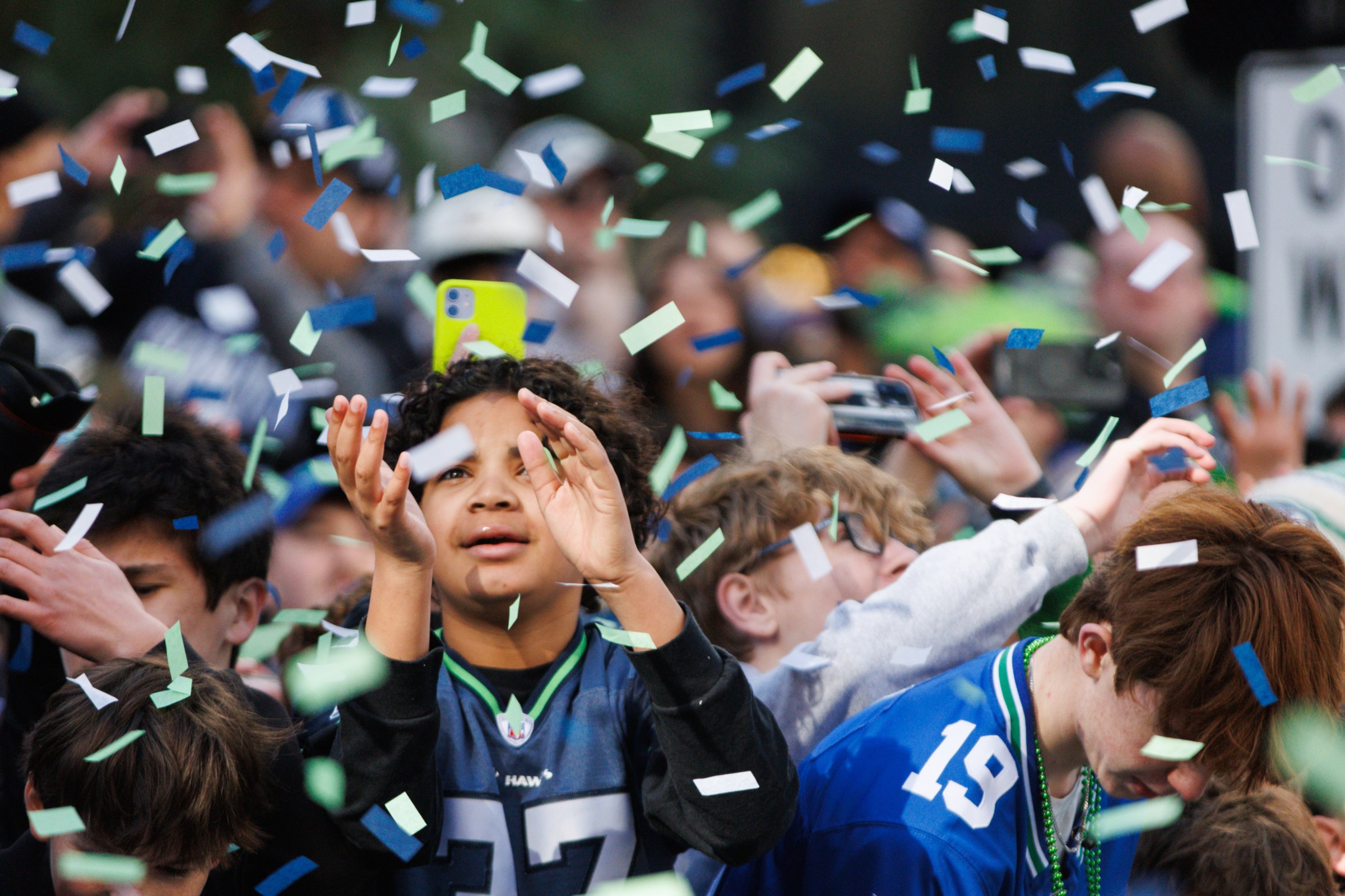 Feb 11, 2026; Seattle, WA, USA; Fans reach for confetti during Seattle Seahawks Super Bowl LX parade. Mandatory Credit: Kevin Ng-Imagn Images