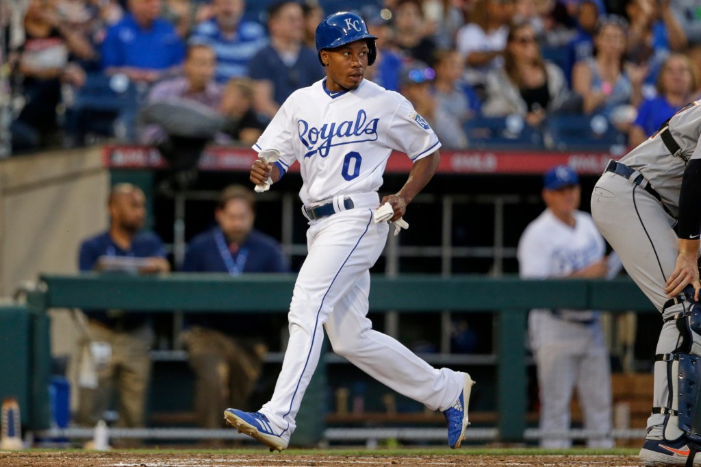 Terrance Gore in a white Kansas City Royals uniform runs on the field.