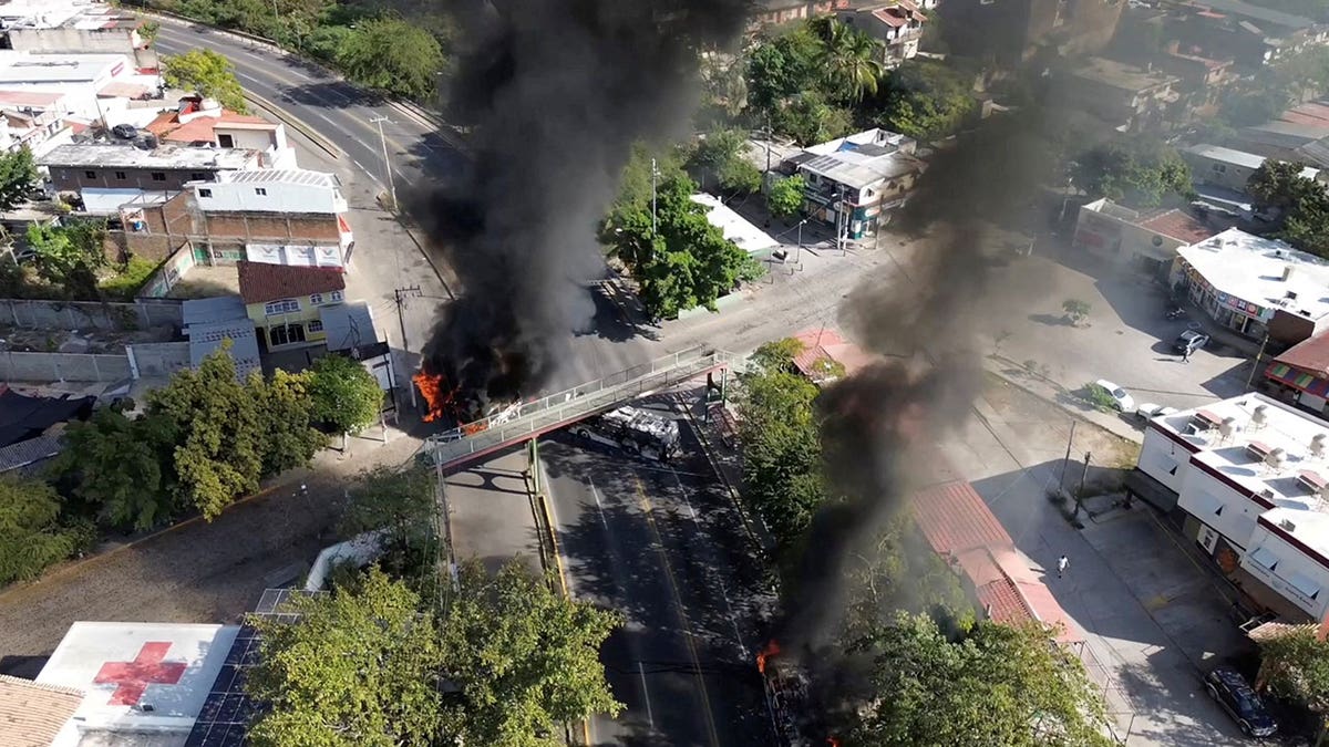 Smoke billows from burning vehicles amid a wave of violence, with torched vehicles and gunmen blocking highways in more than half a dozen states, following a military operation in which a government source said Mexican drug lord Nemesio Oseguera, known as "El Mencho," was killed, in Puerto Vallarta, Jalisco, Mexico, Feb. 22, 2026. 