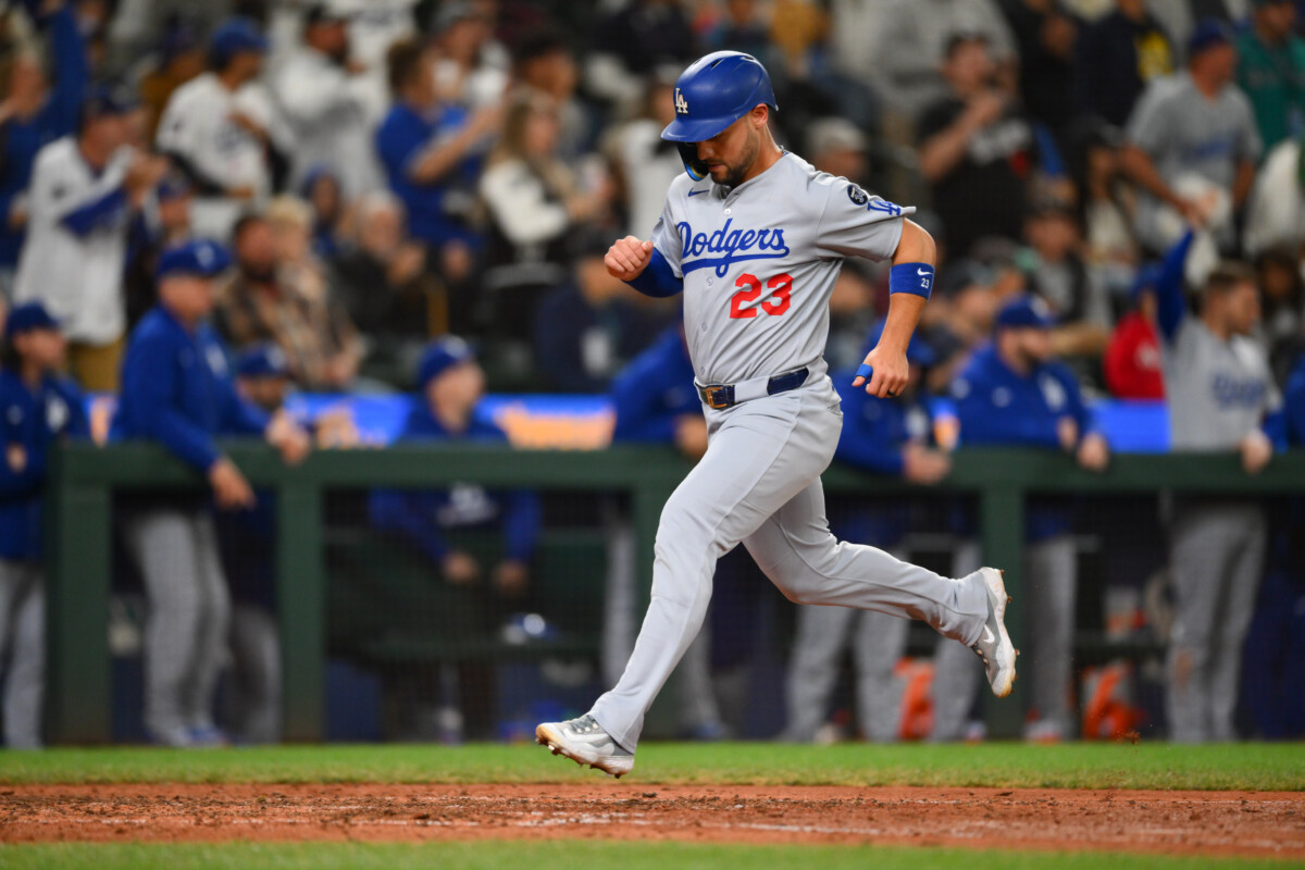 Sep 27, 2025; Seattle, Washington, USA; Los Angeles Dodgers left fielder Michael Conforto (23) scores a run against the Seattle Mariners during the ninth inning at T-Mobile Park. Mandatory Credit: Steven Bisig-Imagn Images