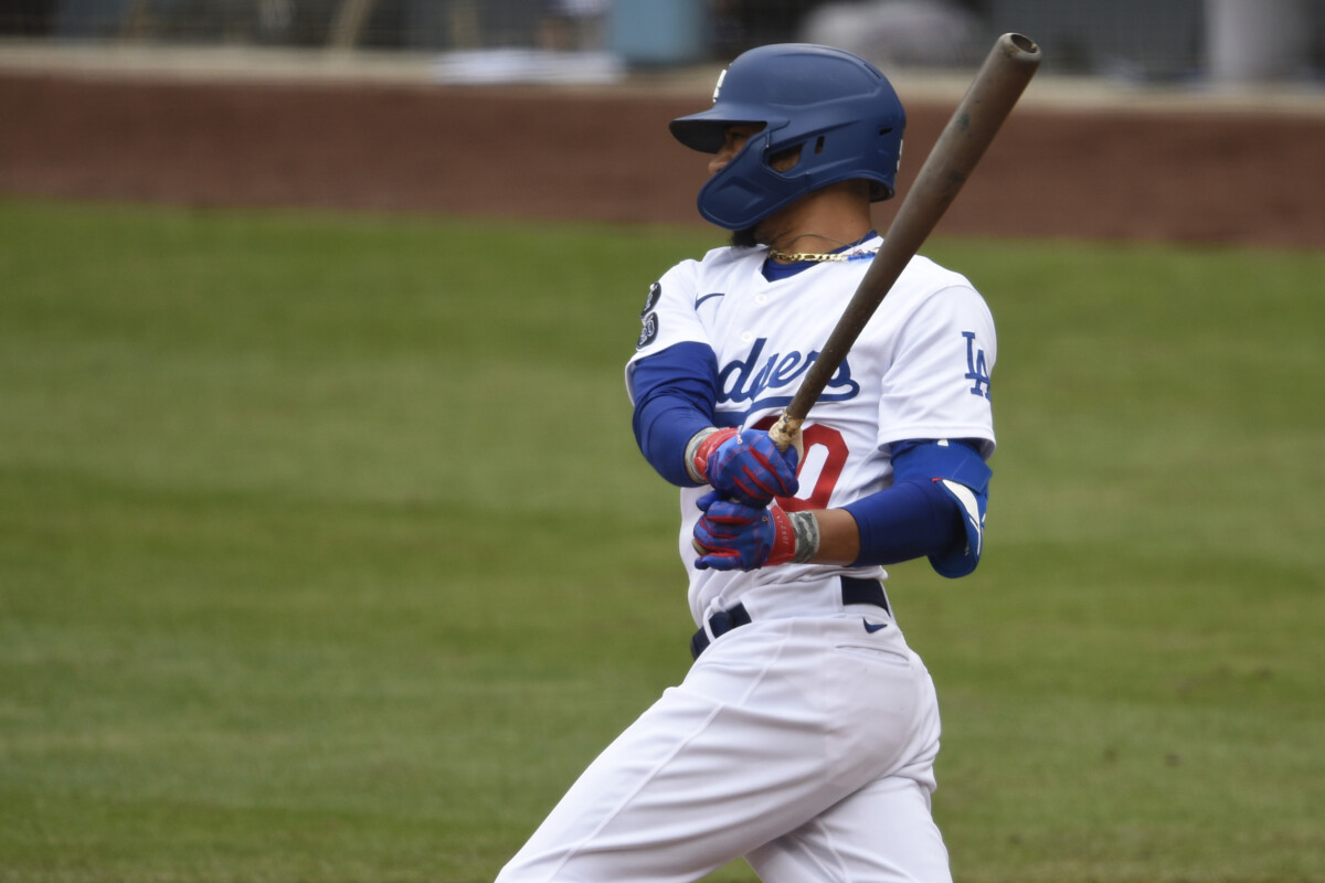 May 16, 2021; Los Angeles, California, USA; Los Angeles Dodgers center fielder Mookie Betts (50) follows through on a swing for an RBI single during the second inning against the Miami Marlins at Dodger Stadium. Mandatory Credit: Kelvin Kuo-USA TODAY Sports