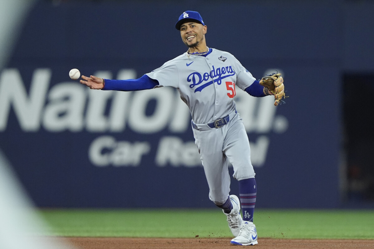 Nov 1, 2025; Toronto, Ontario, CAN; Los Angeles Dodgers shortstop Mookie Betts (50) throws to first for an out against Toronto Blue Jays third baseman Ernie Clement (22) in the fourth inning during game seven of the 2025 MLB World Series at Rogers Centre. Mandatory Credit: John E. Sokolowski-Imagn Images