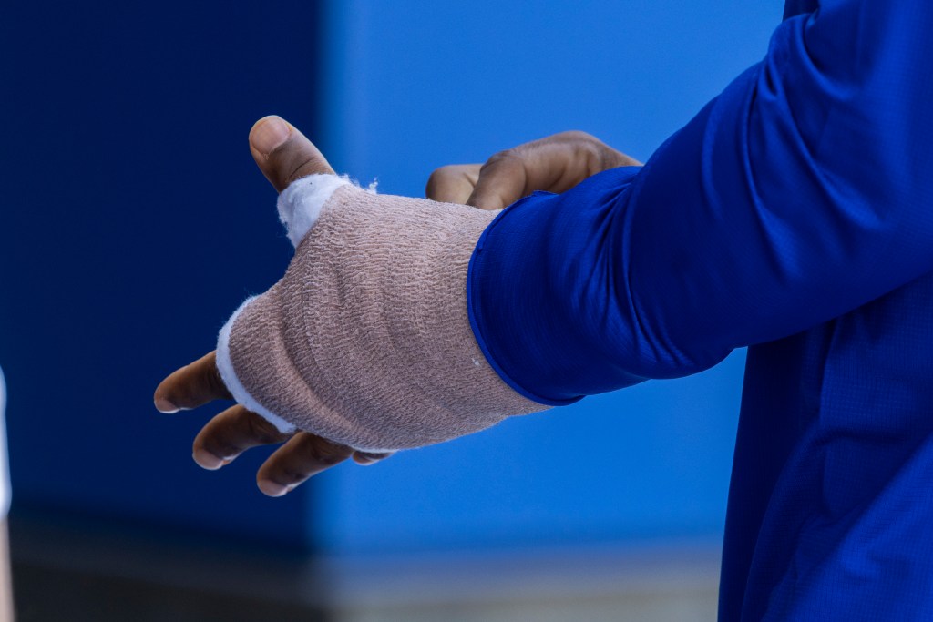 Francisco Lindor's bandaged left hand and blue sleeve.