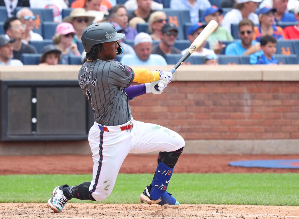 Luisangel Acuña hitting an RBI go-ahead double during a New York Mets game.