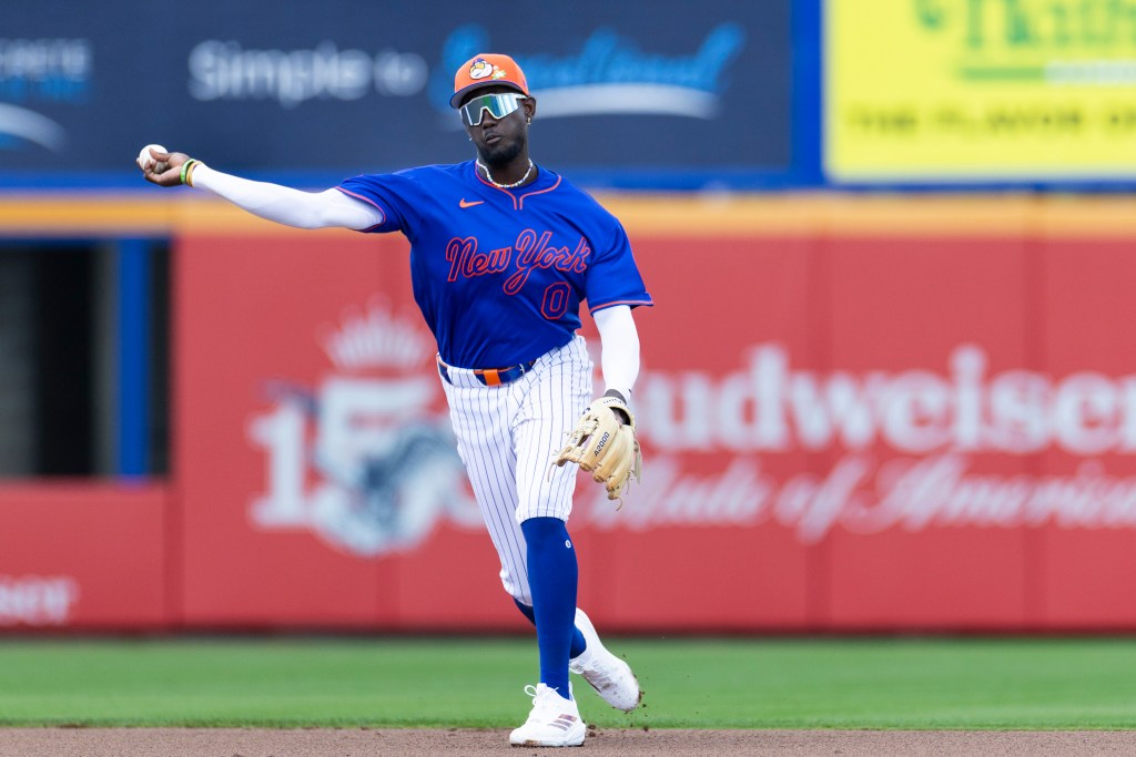 New York Mets shortstop Ronny Mauricio throwing a baseball during Spring Training.