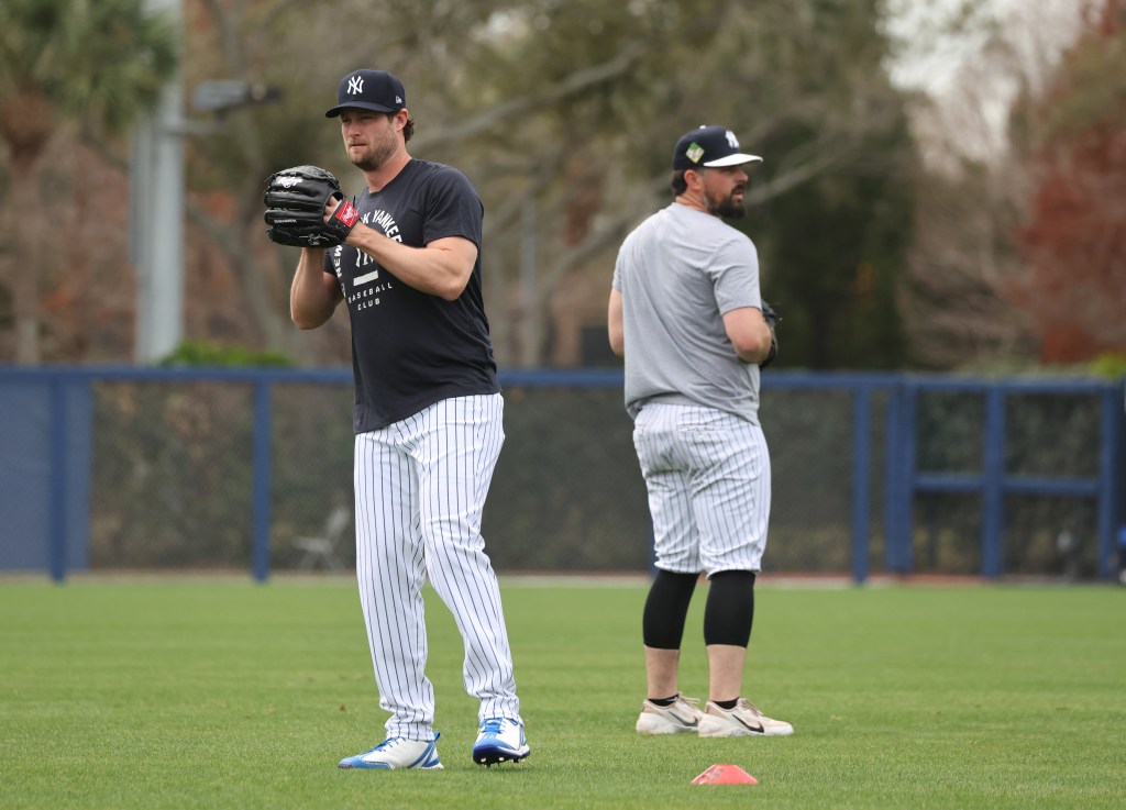 New York Yankees pitchers Gerrit Cole and Carlos Rodón throwing on a back field at Steinbrenner Field.