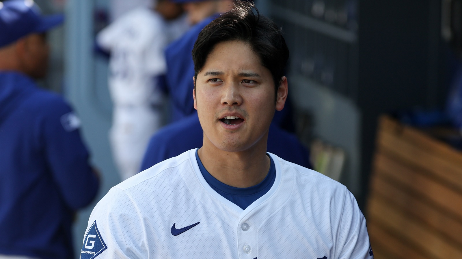 Shohei Ohtani in a Dodgers jersey in the dugout