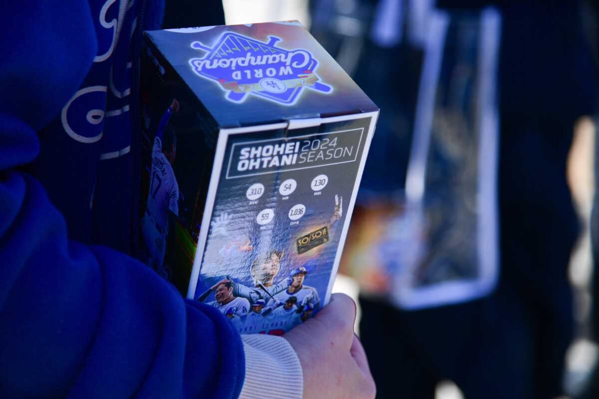 Apr 2, 2025; Los Angeles, California, USA; Spectators receive Shohei Ohtani bobblehead before the Los Angeles Dodgers play against the Atlanta Braves at Dodger Stadium. Mandatory Credit: Gary A. Vasquez-Imagn Images