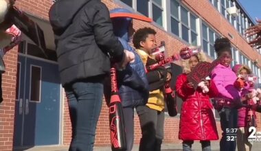 Orioles surprise students celebrating academic improvement at Harlem Park
