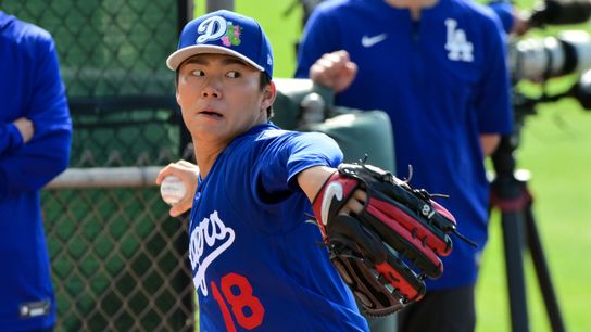 Los Angeles Dodgers pitcher Yoshinobu Yamamoto (18) throws during a Spring Training workout at Camelback Ranch. 