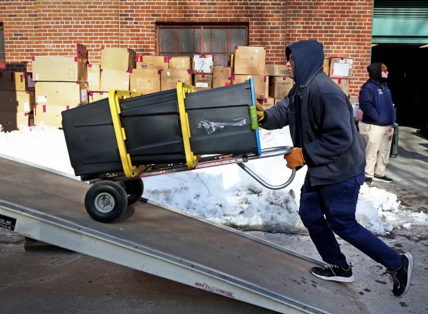 Workers load up for spring training during Red Sox Truck Day outside Fenway Park.(Nancy Lane/Boston Herald)