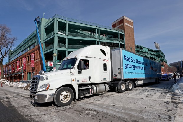 The truck pulls away from Fenway Park after workers loaded it for spring training during Red Sox Truck Day on Monday. (Nancy Lane/Boston Herald)