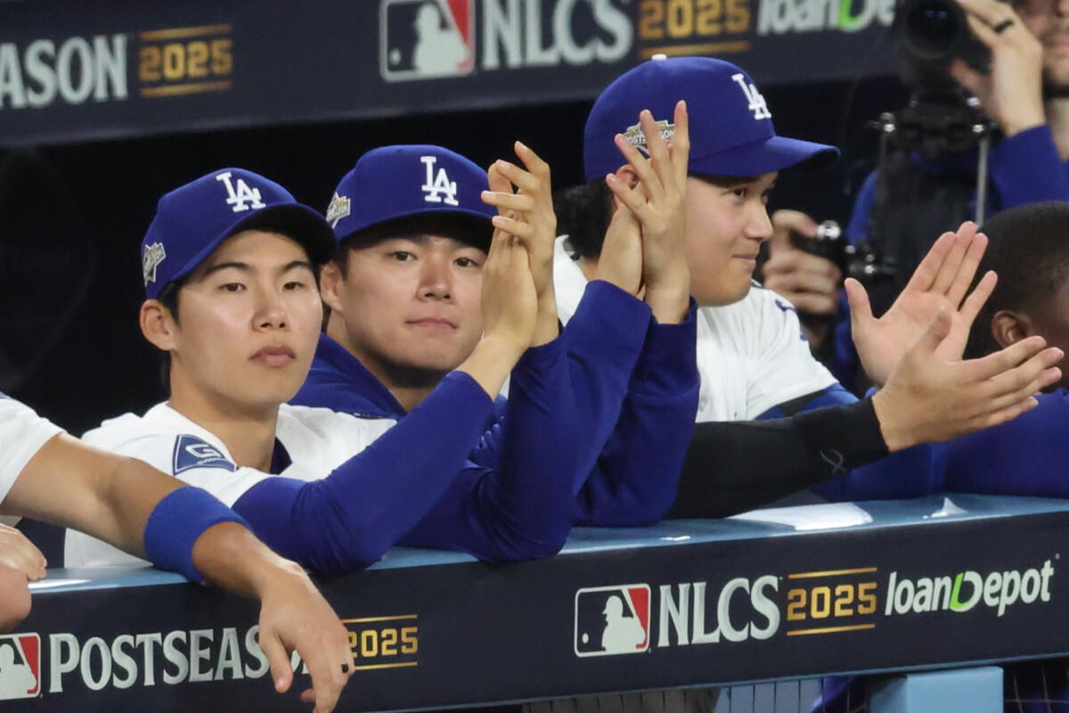 Oct 17, 2025; Los Angeles, California, USA; Los Angeles Dodgers second baseman Hyeseong Kim (6), pitcher Yoshinobu Yamamoto (18), and two-way player Shohei Ohtani (17) watch the game from the dugout in the ninth inning against the Milwaukee Brewers in game four of the NLCS round for the 2025 MLB playoffs at Dodger Stadium. Mandatory Credit: Kiyoshi Mio-Imagn Images