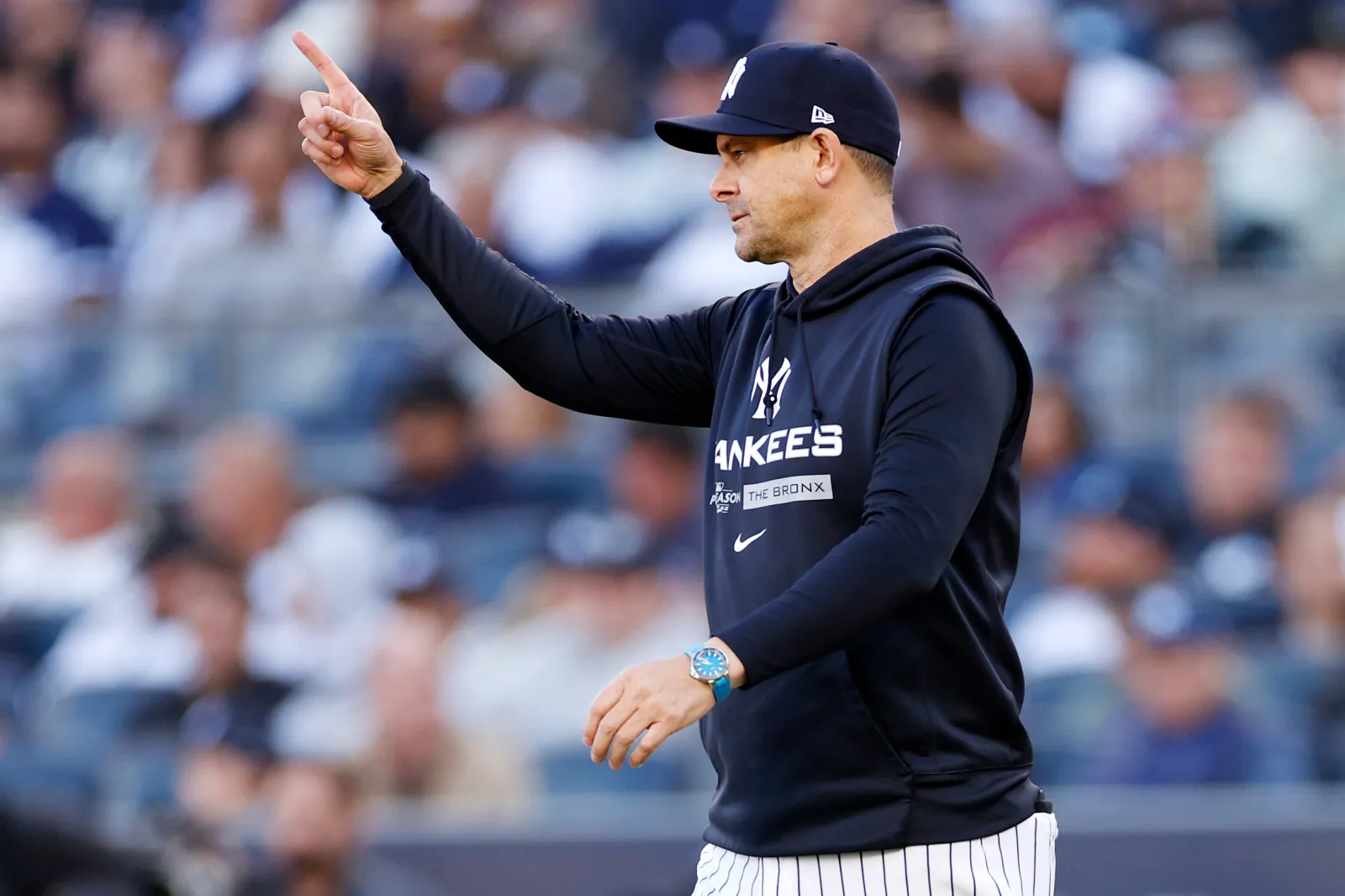Yankees manager Aaron Boone signals for a bullpen pitcher.