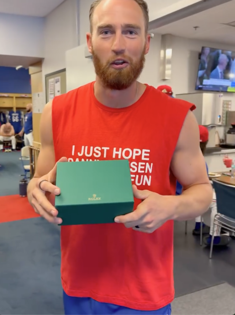 Texas Rangers star Brandon Nimmo holding a Rolex gift box.