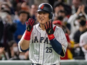 Japan's Kazuma Okamoto reacts after hitting three-run home run during the World Baseball Classic against Italy in 2023.