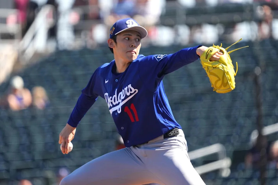 Los Angeles Dodgers starting pitcher Roki Sasaki (11) pitches against the Cleveland Guardians during the first inning at Goodyear Ballpark.