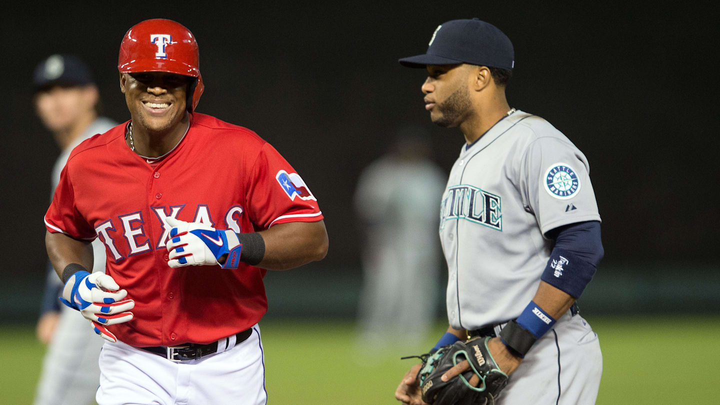 Apr 27, 2015; Arlington, TX, USA; Texas Rangers third baseman Adrian Beltre (29) runs past Seattle Mariners second baseman Robinson Cano (22) after called out for being hit with a live ball during the fourth inning at Globe Life Park in Arlington. Mandatory Credit: Jerome Miron-Imagn Images