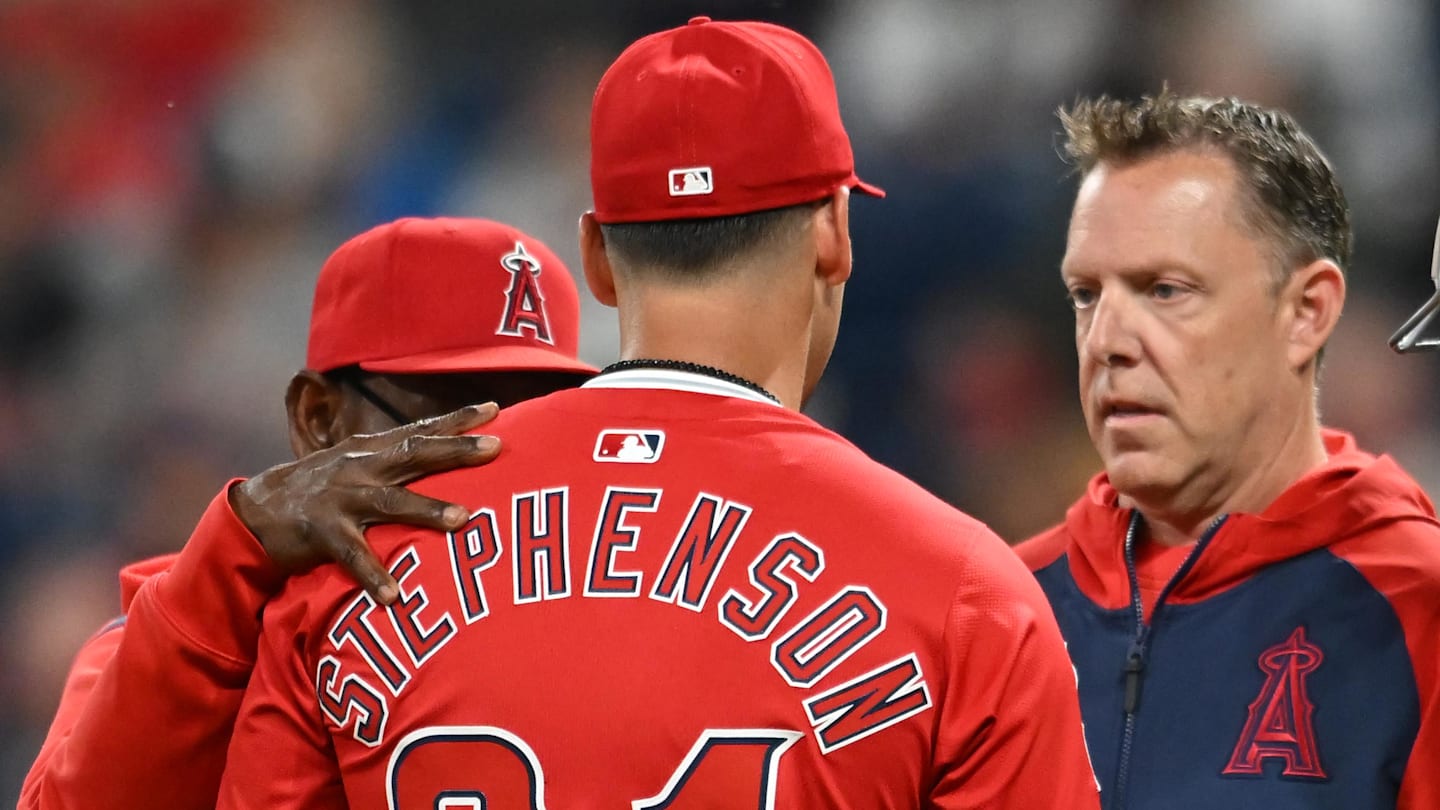 May 30, 2025; Cleveland, Ohio, USA; Los Angeles Angels relief pitcher Robert Stephenson (24) is looked at by a trainer after being injured during the seventh inning against the Cleveland Guardians at Progressive Field. Mandatory Credit: Ken Blaze-Imagn Images