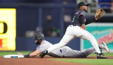 Mar 28, 2026; Miami, Florida, USA;  Colorado Rockies center fielder Brenton Doyle (9) steals second base in the second inning as Miami Marlins second baseman Xavier Edwards (9) waits for the ball at loanDepot Park. Mandatory Credit: Jim Rassol-Imagn Images