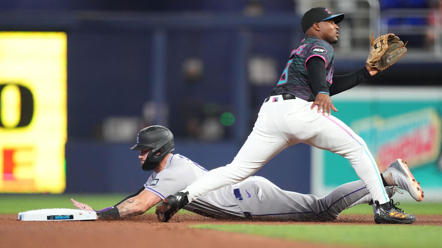 Mar 28, 2026; Miami, Florida, USA;  Colorado Rockies center fielder Brenton Doyle (9) steals second base in the second inning as Miami Marlins second baseman Xavier Edwards (9) waits for the ball at loanDepot Park. Mandatory Credit: Jim Rassol-Imagn Images