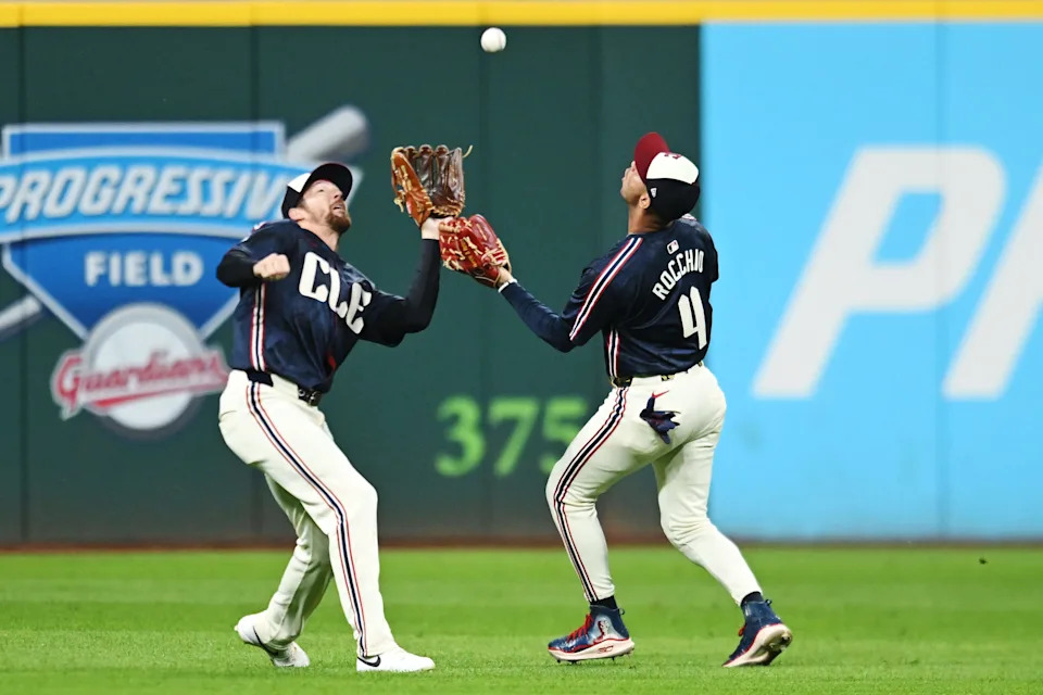 Cleveland Guardians second baseman Brayan Rocchio (4) and center fielder Daniel Schneemann nearly collide as Schneemann catches a ball during a game against the Texas Rangers on Sept. 26, 2025, in Cleveland.