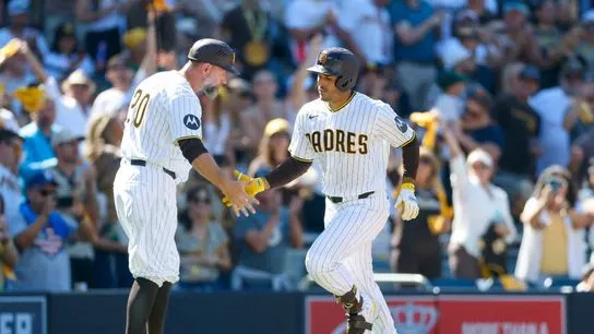 Mar 26, 2026; San Diego, California, USA; San Diego Padres left fielder Ramon Laureano (5) celebrates with third base coach Bob Henley (20) after hitting a one run home run during the seventh inning against the Detroit Tigers at Petco Park.