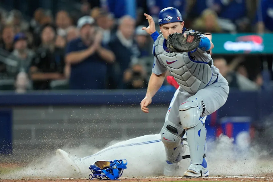 Toronto Blue Jays second baseman Isiah Kiner-Falefa (7) is out against Los Angeles Dodgers catcher Will Smith (16) in the ninth inning during game seven of the 2025 MLB World Series at Rogers Centre.