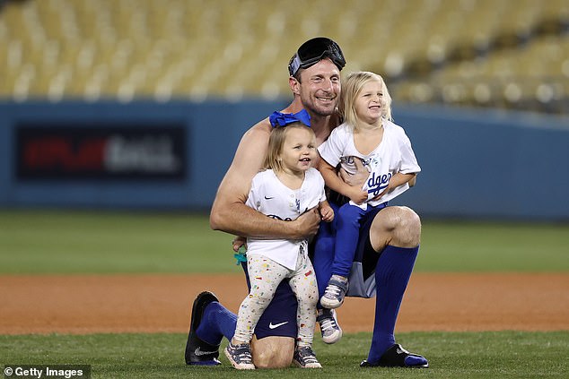 Scherzer celebrates with daughters Brooke and Kacey after a playoff win with LA in 2021